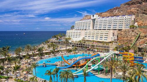 a resort with a water park with a slide at Apartment with views of sea and mountains in Taurito