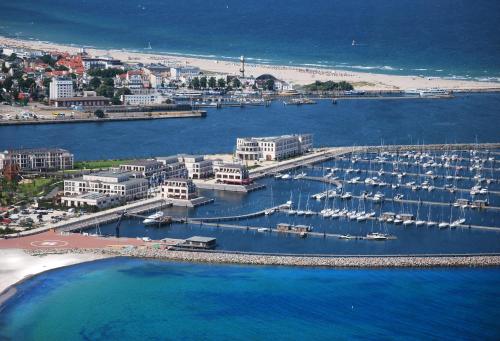 an aerial view of a harbor with boats in the water at Yachthafenresidenz Hohe Düne in Warnemünde
