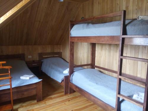 a room with three bunk beds in a cabin at Home Hotel in Kamianets-Podilskyi