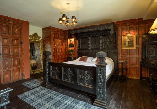 a bedroom with a large bed with wooden cabinets at Ye Spotted Dogge in Portsmouth