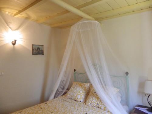a bedroom with a bed with a canopy at Casa da Eira in Cerdeira