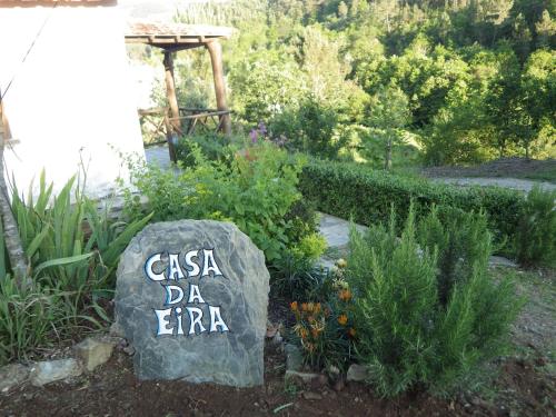 a garden with a sign that says casa da eminem at Casa da Eira in Cerdeira