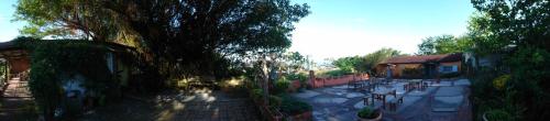 a courtyard with chairs and trees and a building at 自然海naturalhigh in Dahan