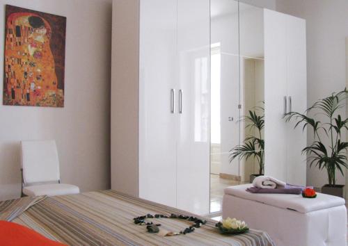 1 dormitorio con 1 cama y una pintura en la pared en Ibiscus B&B, en Castro di Lecce