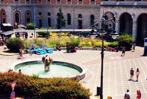 a large fountain in the middle of a city at Stazione22 B&B in Pisa