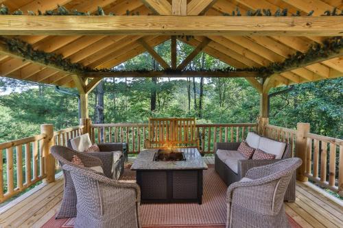 a screened porch with a fireplace on a wooden deck at Heaven's Gate in Ellijay