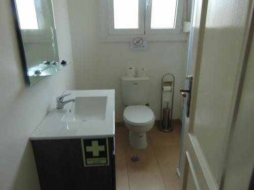 a small bathroom with a toilet and a sink at Bem Me Quer in Almada