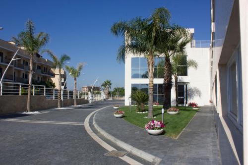 a street with palm trees and a building at DubaiVillage in Camposano
