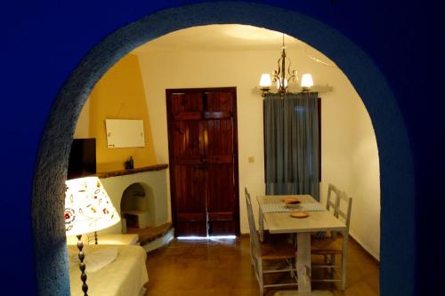 a room with a table and a dining room at Cretan Village Hotel in Agios Nikolaos