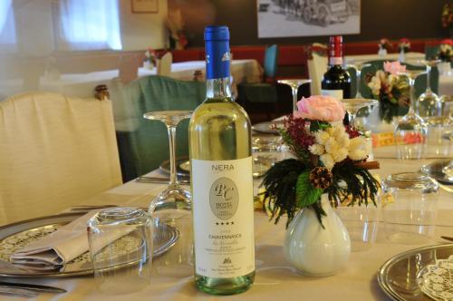 a bottle of wine sitting on top of a table at Hotel Baita Clementi in Bormio