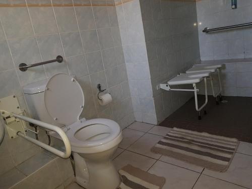 a bathroom with a toilet and a sink at Rocha's Hotel in Oshakati