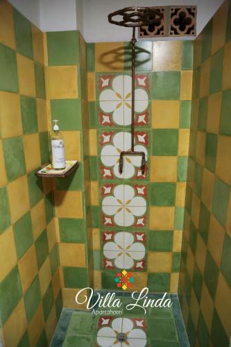 a bathroom with a shower with colorful tiles at Villa Linda ApartaHotel in Jericó