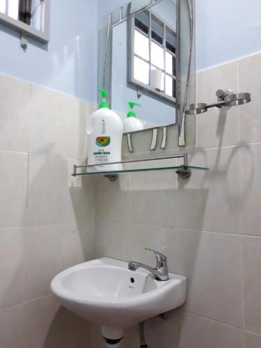 a bathroom with a sink and a mirror at Homestay Bukit Katil Melaka 10Pax 3R3B in Malacca