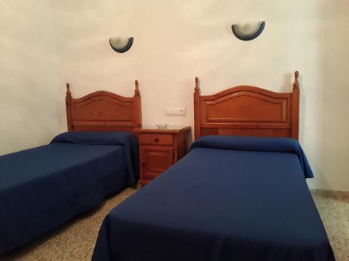 Säng eller sängar i ett rum på Hostal Miguel