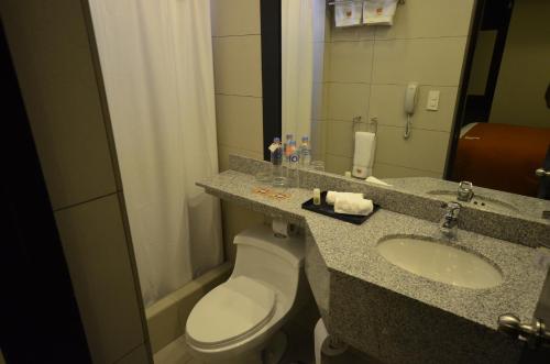 a bathroom with a toilet and a sink and a phone at qp Hotels Arequipa in Arequipa