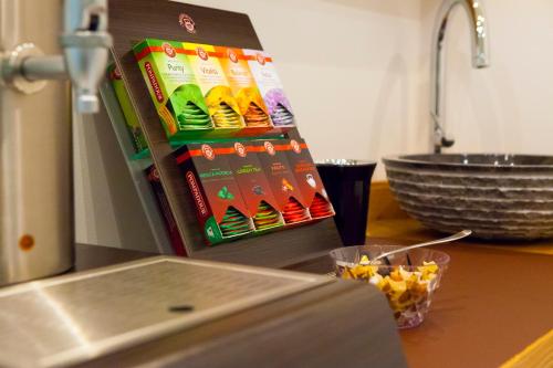 a kitchen counter with a refrigerator with some food at Garni Hotel Miara - Your Dolomites Home in Selva di Val Gardena