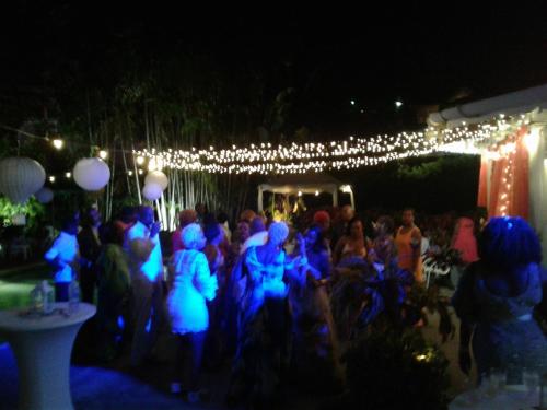 a group of people standing under a group of lights at Plantation Beach Villas in Black Rock