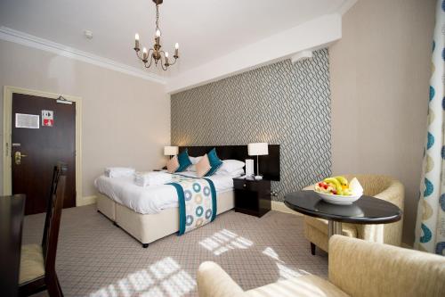 a hotel room with a bed and a table at Crown & Mitre Hotel in Carlisle
