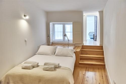 a bedroom with a large bed with two pillows on it at PortoSense Almada in Porto