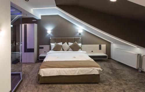 a bedroom with a large bed in a attic at Hotel & Restaurant Ponte Bianco in Vranje