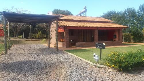 a small house with a sign in front of it at Chales Recanto das Seriemas in São Roque de Minas