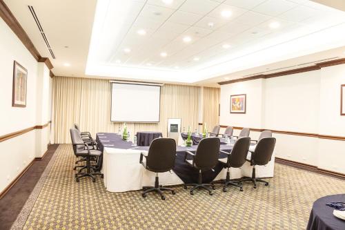 a conference room with a long table and chairs at Barceló Guatemala City in Guatemala