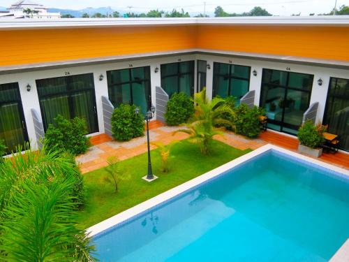 a house with a swimming pool in front of it at Shafa Resort in Mae Sot