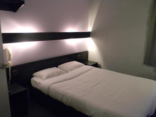 Postel nebo postele na pokoji v ubytování Class-Hôtel