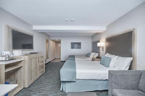 Postel nebo postele na pokoji v ubytování Vittoria Hotel & Suites