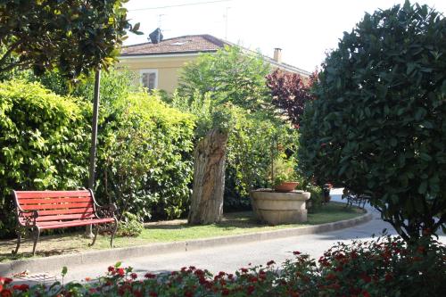 a park bench sitting in the middle of a street at Hotel Girasole in Civitanova Marche