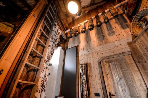 a room with wooden walls and a door with windows at Hotel Du Grand Paradis - 1899 Auberge Boutique in Cogne