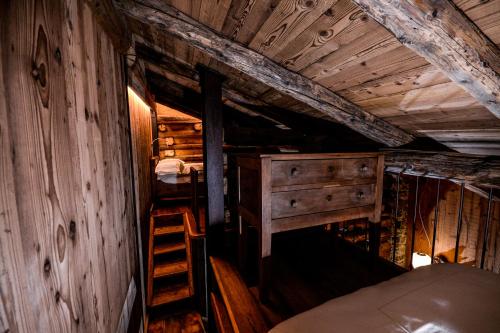 an attic room with a bunk bed and a ladder at Hotel Du Grand Paradis - 1899 Auberge Boutique in Cogne