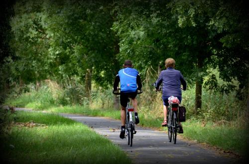 two people riding bikes down a path at Vakantiewoning De Machuut in Lo-Reninge