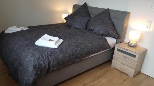 a bedroom with a bed and a night stand with two lamps at Cloud 7 II in Heinsberg