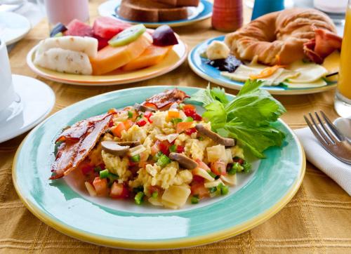 a plate of food on a table with plates of food at Hotel Solymar in Puerto Ayora