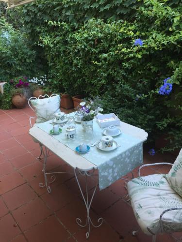 a white table with dishes on it on a patio at Calycanto in Tempio Pausania