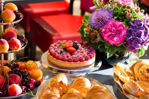 a table topped with lots of different types of food at Hotel Monceau Wagram in Paris