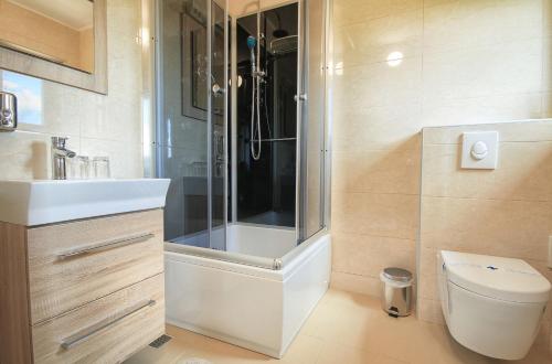 a bathroom with a shower and a toilet and a sink at Donna Plitvice Lakes in Grabovac