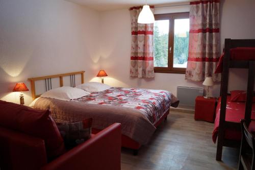 a bedroom with a large bed and a window at Hotel - Restaurant Le Blanchon in Selonnet