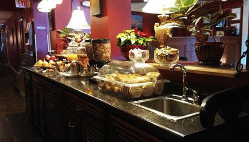 a kitchen counter with a sink with food on it at Inn at St John Portland In-Town in Portland