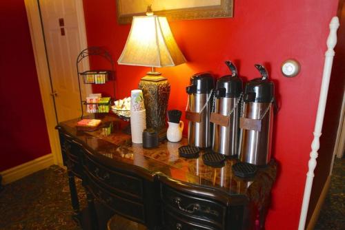 a table with a lamp on a red wall at Inn at St John Portland In-Town in Portland