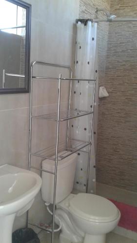 Un baño con inodoro, lavabo y ducha. en Chicama Surf Camp, en Puerto Chicama