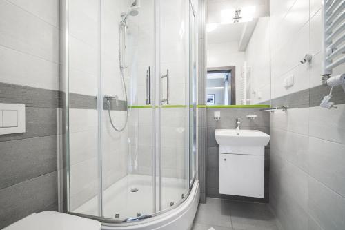 a bathroom with a shower and a toilet and a sink at Villa Baltica II in Rewa