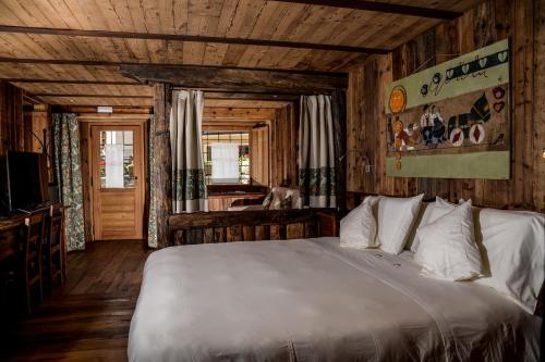 a bedroom with a bed in a wooden room at Hotel Du Grand Paradis - 1899 Auberge Boutique in Cogne