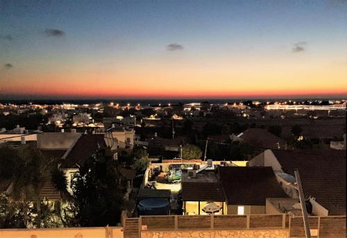 a view of a city skyline at sunset at 2 bedroom apartment in Atlit, Haifa district in Atlit