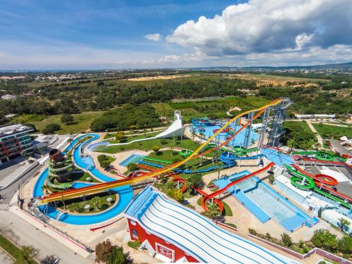 an aerial view of a water park with a roller coaster at Porque Você Merece in Quarteira