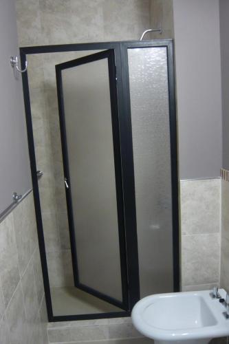 a bathroom with a shower and a sink and a mirror at Mein Gästehaus in Gualeguaychú