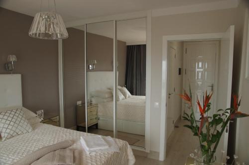 a bedroom with a mirror and a bed at Sunny Apartment Colina Blanca in Adeje