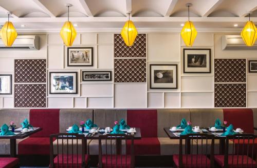 a dining room with tables and chairs and lights at Lantana Riverside Hoi An Boutique Hotel & Spa in Hoi An