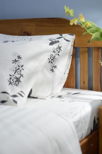 a bed with black and white pillows on it at Amor's Place in Puerto Princesa City
